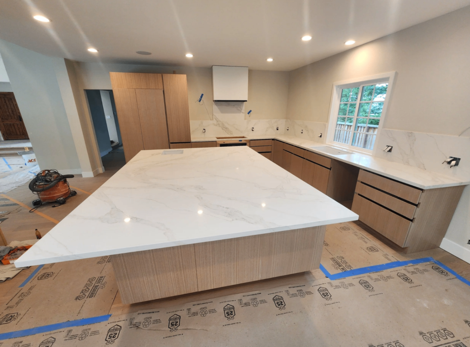 Modern white quartz island with matching perimeter counters