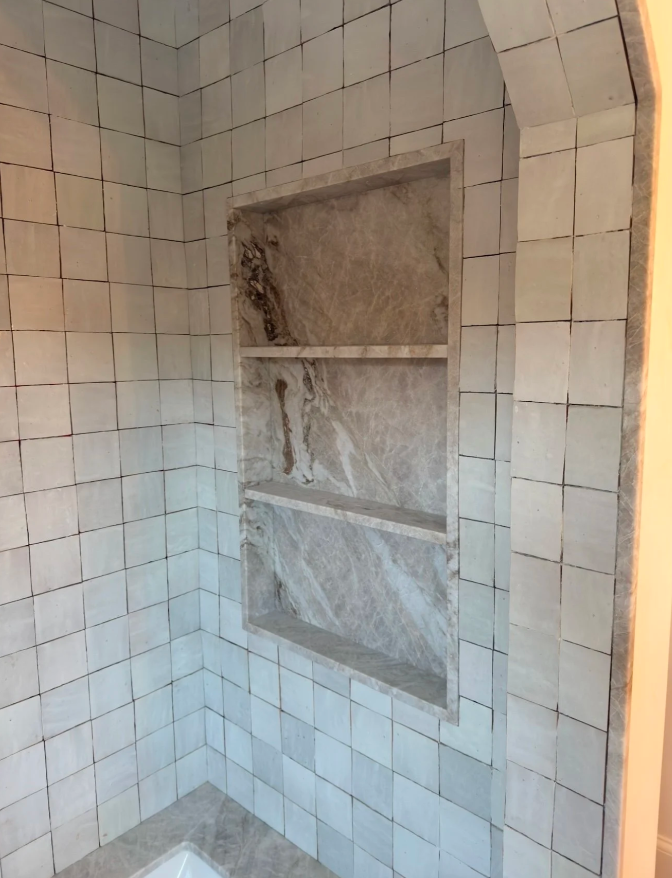 Quartzite shower niche with shelves